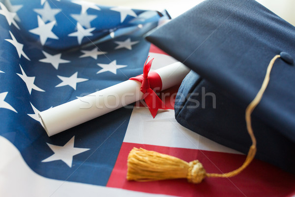 bachelor hat and diploma on american flag Stock photo © dolgachov