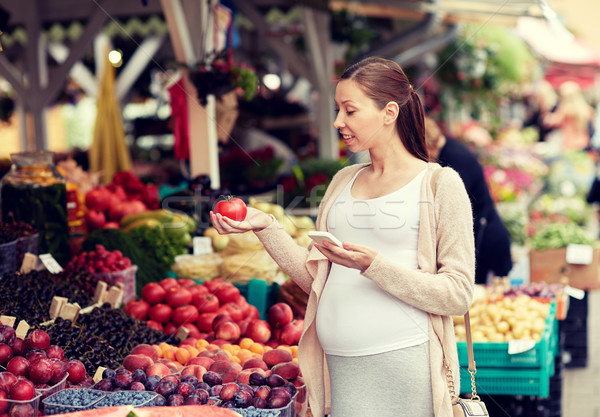 pregnant woman with smartphone at street market Stock photo © dolgachov