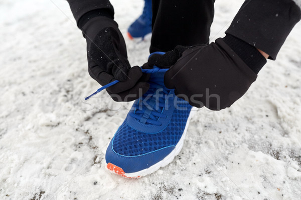 close up of man tying shoe lace in winter outdoors Stock photo © dolgachov