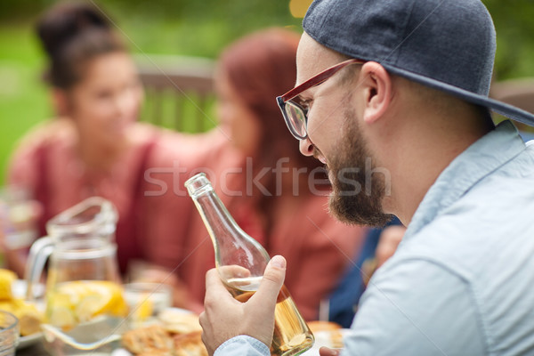 happy man with beer friends at summer garden party Stock photo © dolgachov