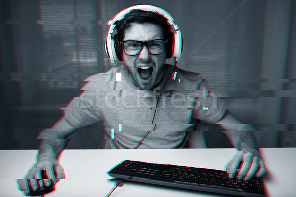 Hombre auricular jugando ordenador videojuegos casa Foto stock © dolgachov