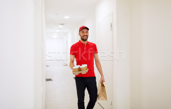 man delivering coffee and food to customer home Stock photo © dolgachov
