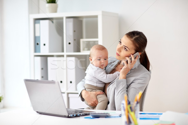 businesswoman with baby and smartphone at office Stock photo © dolgachov
