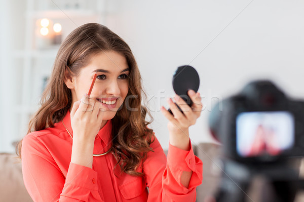 woman with eyebrow pencil recording video at home Stock photo © dolgachov