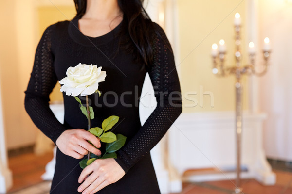 woman with white rose at funeral in church Stock photo © dolgachov