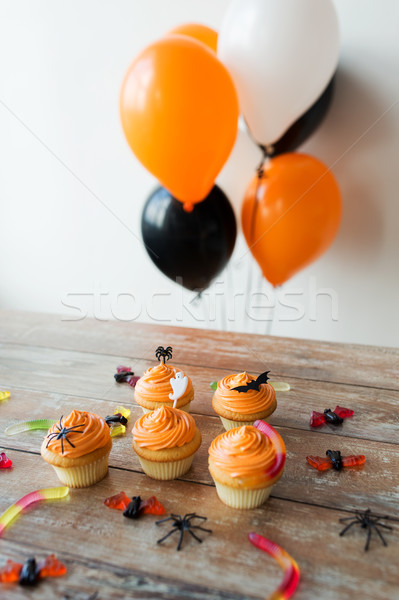 halloween party cupcakes and candies on table Stock photo © dolgachov