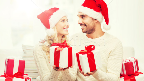 happy couple at home exchanging christmas gifts Stock photo © dolgachov