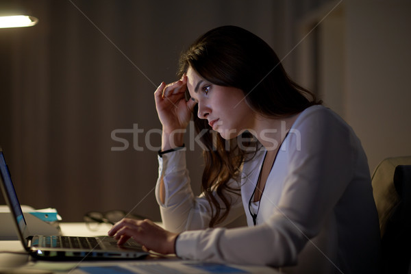 businesswoman with laptop at night office Stock photo © dolgachov