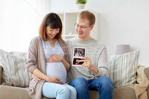 Boldog pár ultrahang képek otthon terhesség Stock fotó © dolgachov