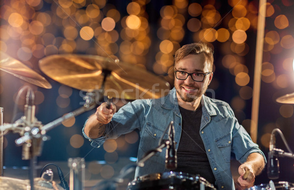 musician or drummer playing drum kit at concert Stock photo © dolgachov