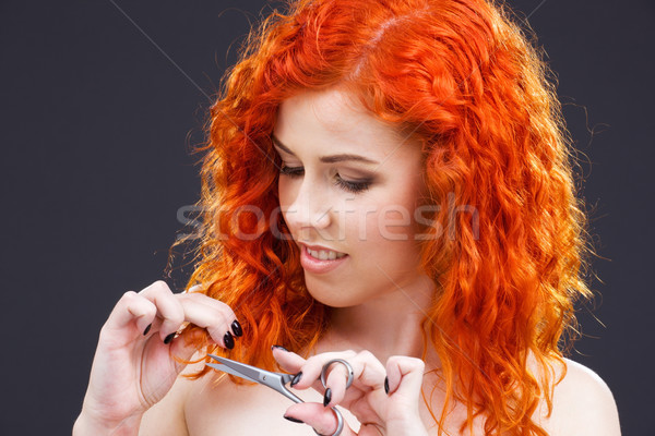 Stock photo: redhead with scissors