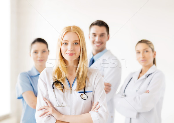 female doctor in front of medical group Stock photo © dolgachov
