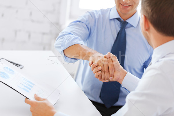 Stock photo: businessmen shaking hands in office