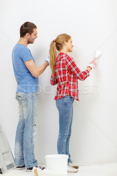 smiling couple doing renovations at home Stock photo © dolgachov