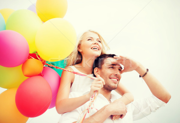 couple with colorful balloons at seaside Stock photo © dolgachov