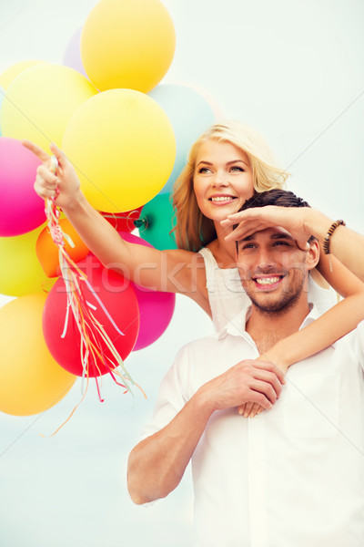 couple with colorful balloons at seaside Stock photo © dolgachov