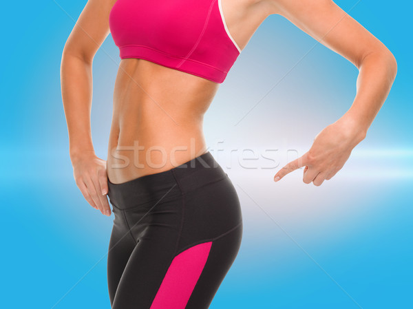 close up of sporty woman pointing at her buttocks Stock photo © dolgachov