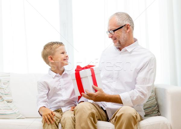 christmas and people concept - smiling grandfather and grandson