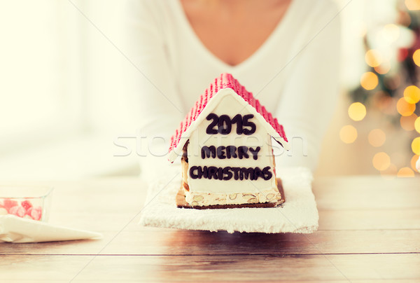 close up of woman showing gingerbread house Stock photo © dolgachov