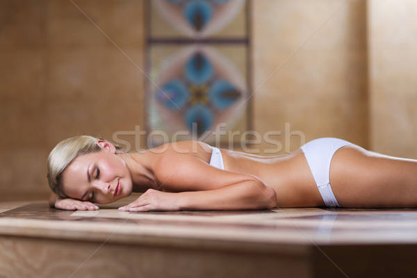 young woman lying on hammam table in turkish bath Stock photo © dolgachov