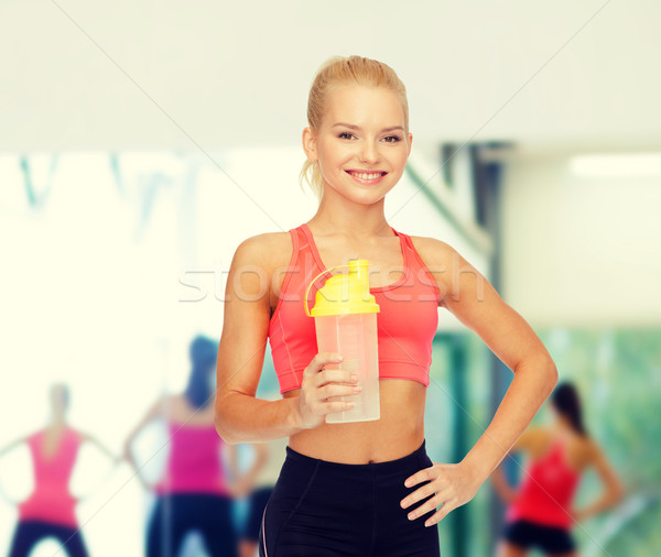 Uśmiechnięty kobieta białko shake butelki Zdjęcia stock © dolgachov