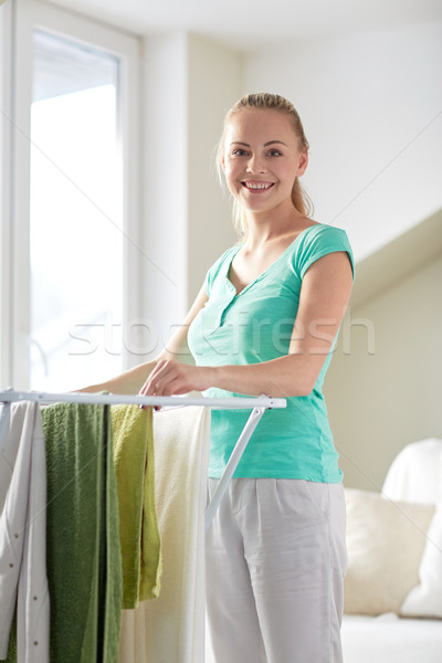 happy woman hanging clothes on dryer at home Stock photo © dolgachov