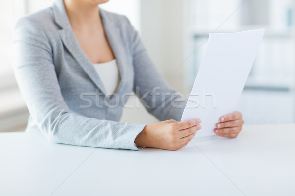 close up of woman reading papers or tax report Stock photo © dolgachov