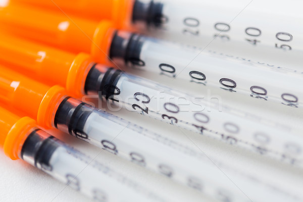 close up of insulin syringes on table Stock photo © dolgachov