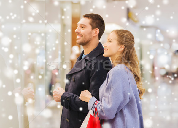 happy young couple with shopping bags in mall Stock photo © dolgachov