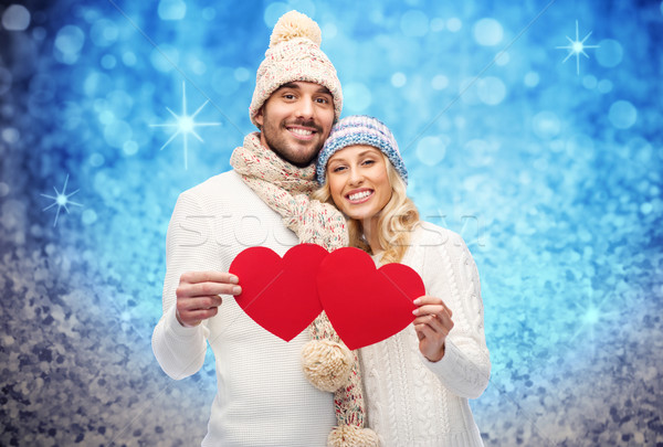 Stock photo: smiling couple in winter clothes with red hearts