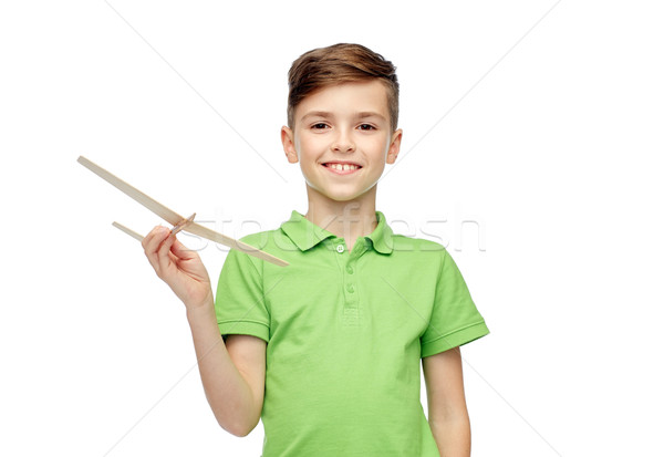 happy boy in green polo t-shirt with toy airplane Stock photo © dolgachov
