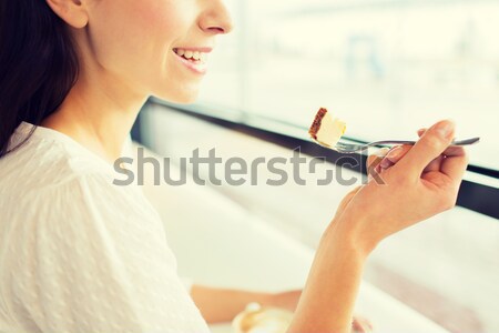 close up of woman eating cake at cafe or home Stock photo © dolgachov