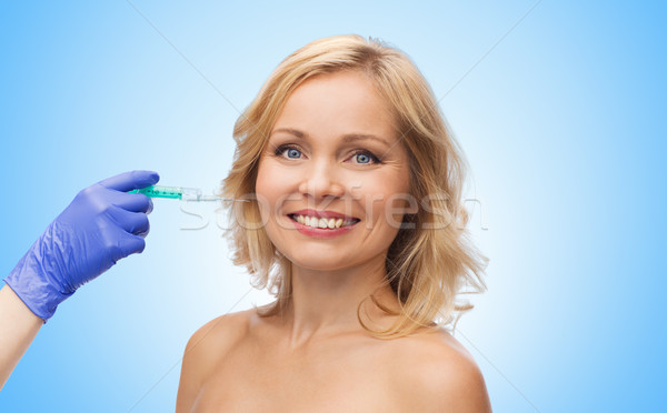 happy woman face and beautician hand with syringe Stock photo © dolgachov
