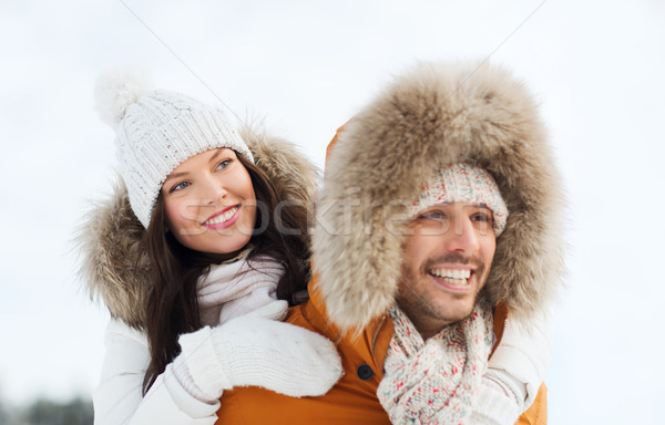 Stock photo: happy couple having fun over winter background