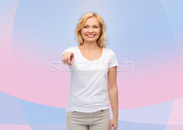 笑顔の女性 白 Tシャツ ポインティング ジェスチャー 広告 ストックフォト © dolgachov