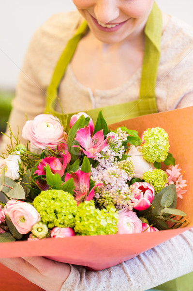 Stock photo: close up of woman with bunch at flower shop