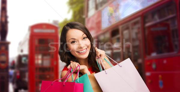 woman with shopping bags over london city street Stock photo © dolgachov