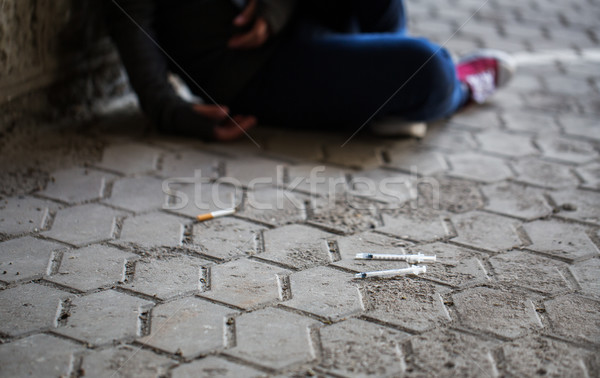 close up of addict woman and drug syringes Stock photo © dolgachov