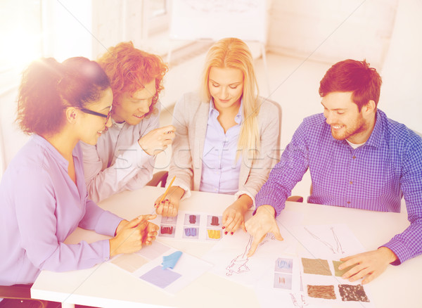 smiling creative team looking at sketch Stock photo © dolgachov