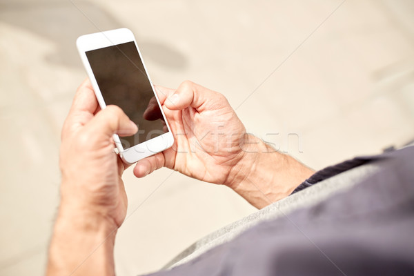 close up of man with smartphone on street Stock photo © dolgachov