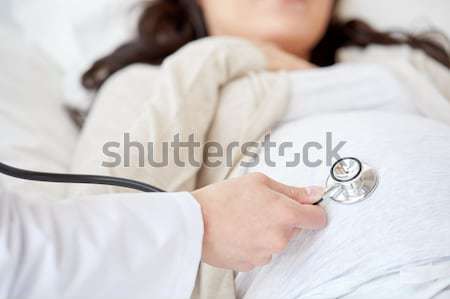 Stock photo: close up of woman with cocoa cup in bed at home