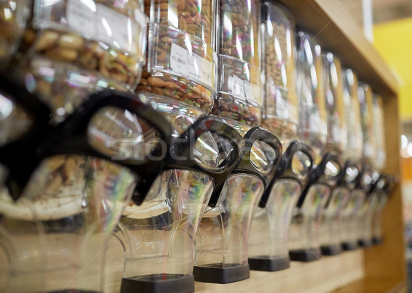 row of jars with nuts and seeds at grocery store Stock photo © dolgachov