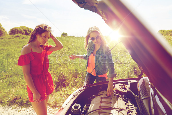 women with open hood of broken car at countryside Stock photo © dolgachov