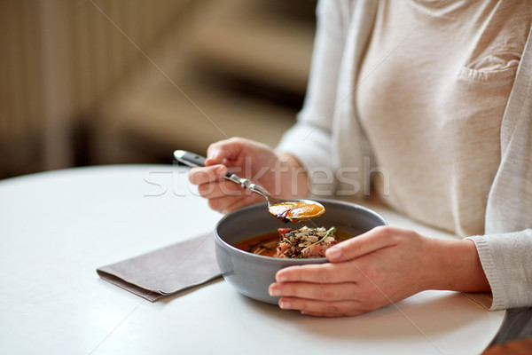 Stock photo: woman eating pumpkin cream soup at restaurant
