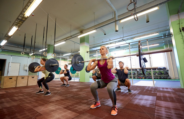 group of people training with barbells in gym Stock photo © dolgachov