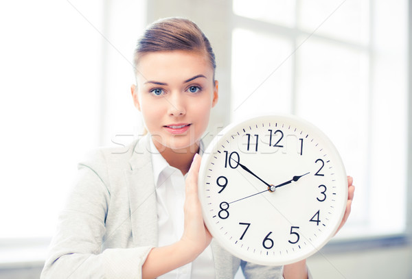 attractive businesswoman showing white clock Stock photo © dolgachov
