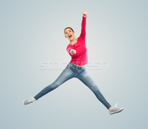 smiling young woman jumping in air Stock photo © dolgachov