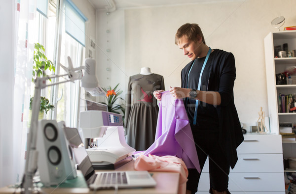 fashion designer with cloth making dress at studio Stock photo © dolgachov