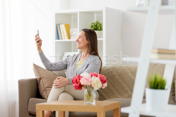 happy woman taking selfie by smartphone at home Stock photo © dolgachov