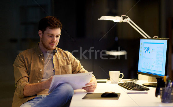 businessman with papers working at night office Stock photo © dolgachov